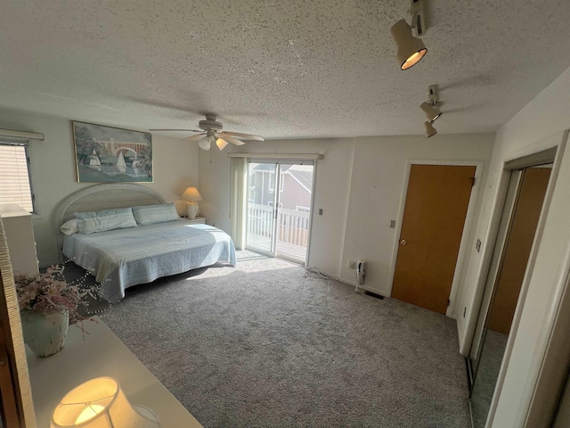 carpeted bedroom with access to exterior, a textured ceiling, a ceiling fan, and rail lighting