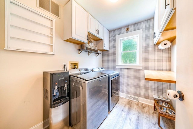 1731 Rte 47, Eldora, NJ 08270 - laundry room featuring wallpapered walls, washing machine and clothes dryer, light wood-type flooring, and cabinet space