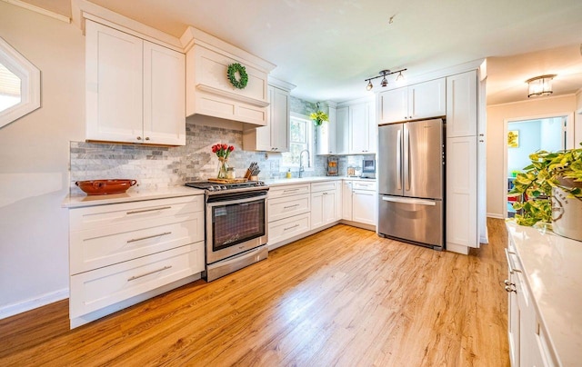 1731 Rte 47, Eldora, NJ 08270 - kitchen featuring stainless steel appliances, light countertops, light wood finished floors, backsplash, and white cabinetry