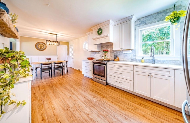 1731 Rte 47, Eldora, NJ 08270 - kitchen with stainless steel range with gas stovetop, light countertops, light wood-style floors, and white cabinetry