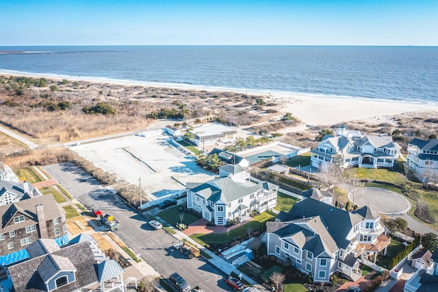 aerial view with a water view and a beach view