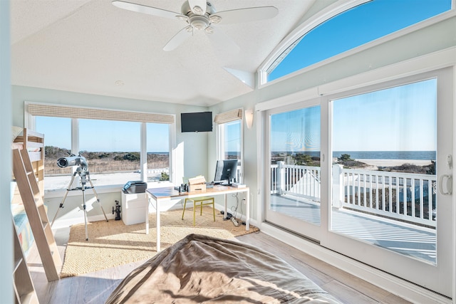 sunroom / solarium featuring ceiling fan and vaulted ceiling