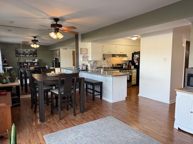1964 E Oak Rd, Vineland, NJ 08360 - dining area featuring dark wood-style flooring, ceiling fan, and baseboards