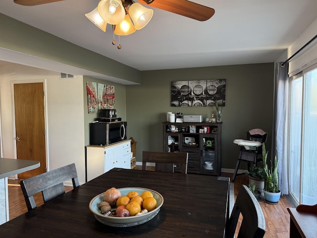1964 E Oak Rd, Vineland, NJ 08360 - dining space with a ceiling fan, wood finished floors, and baseboards