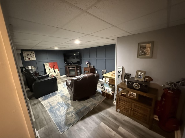 1964 E Oak Rd, Vineland, NJ 08360 - living room featuring a decorative wall, a drop ceiling, and wood finished floors
