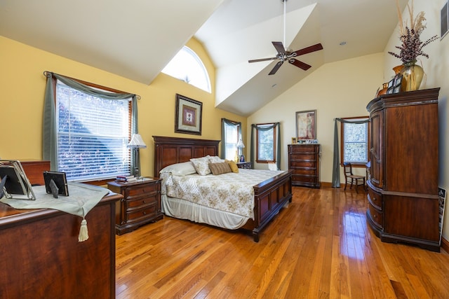 bedroom featuring hardwood / wood-style flooring, high vaulted ceiling, and ceiling fan