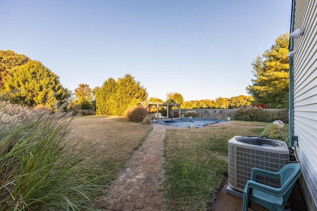 view of yard featuring a pergola and central air condition unit