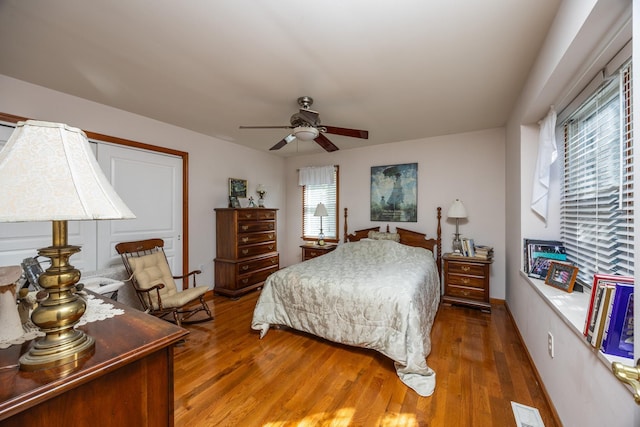 bedroom with ceiling fan and dark hardwood / wood-style flooring