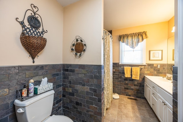 bathroom featuring vanity, tile walls, tile patterned floors, and toilet