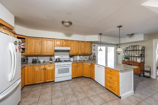 kitchen featuring decorative light fixtures, sink, kitchen peninsula, light stone countertops, and white appliances