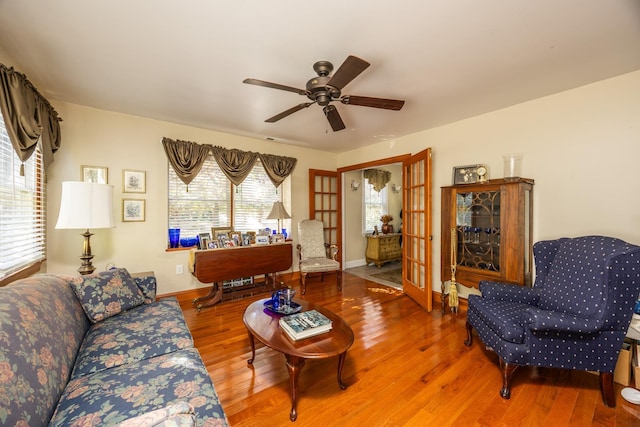 living room featuring wood-type flooring and ceiling fan