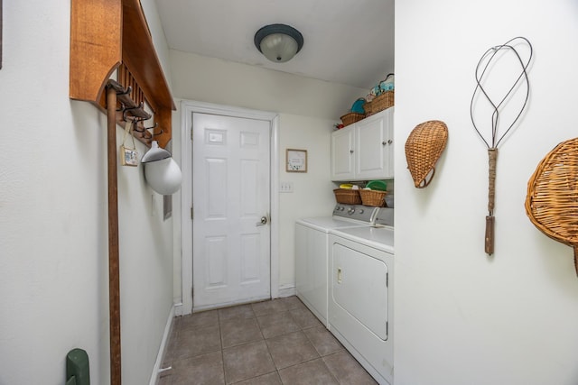 washroom with cabinets, washer and clothes dryer, and light tile patterned floors