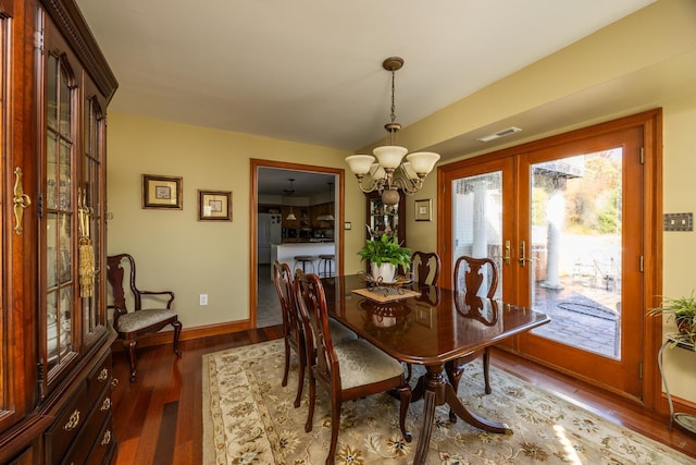 dining room featuring an inviting chandelier, light wood-type flooring, and french doors