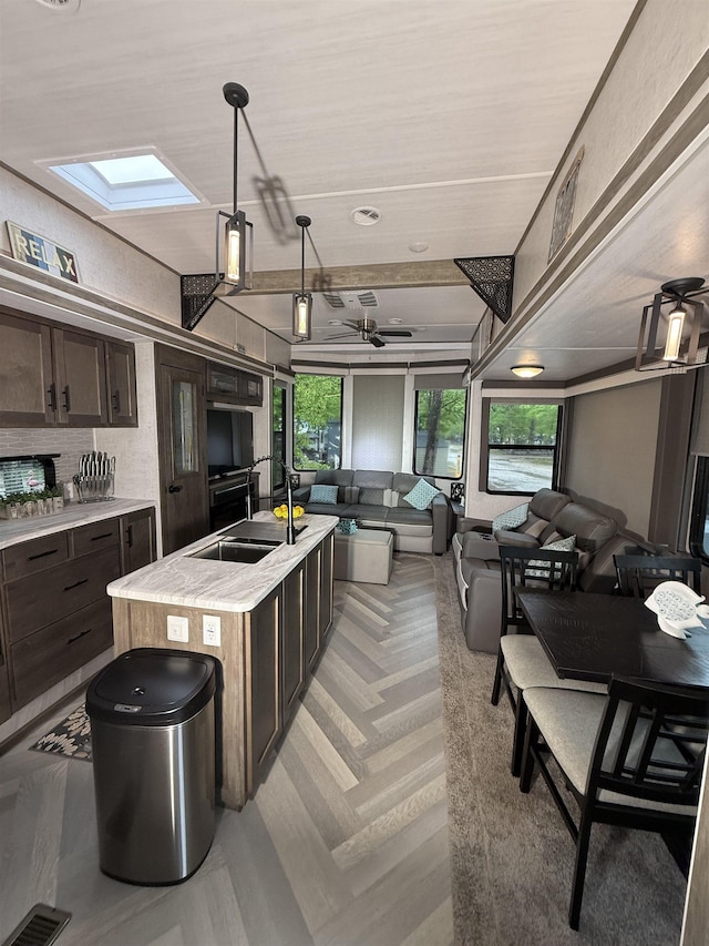 515 Corson Tavern Rd, Ocean View, NJ 08230 - kitchen featuring a sink, open floor plan, dark brown cabinets, and light countertops
