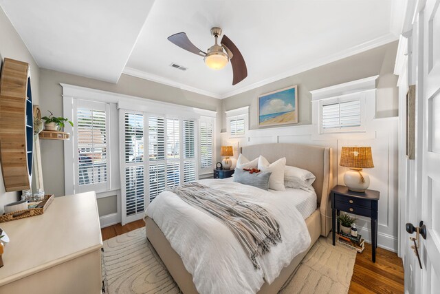 243 110th St, Stone Harbor, NJ 08247 - bedroom with wood finished floors, multiple windows, ornamental molding, and ceiling fan