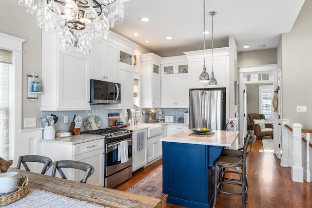 243 110th St, Stone Harbor, NJ 08247 - kitchen with stainless steel appliances, plenty of natural light, a center island, white cabinetry, and recessed lighting