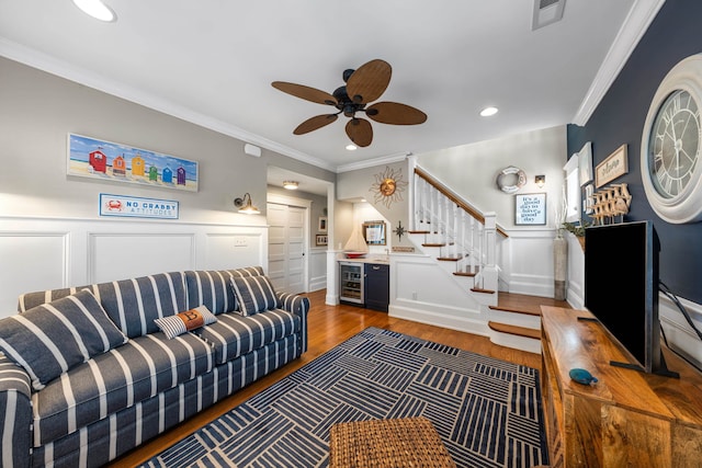 243 110th St, Stone Harbor, NJ 08247 - living area with stairs, a decorative wall, wood finished floors, a ceiling fan, and crown molding