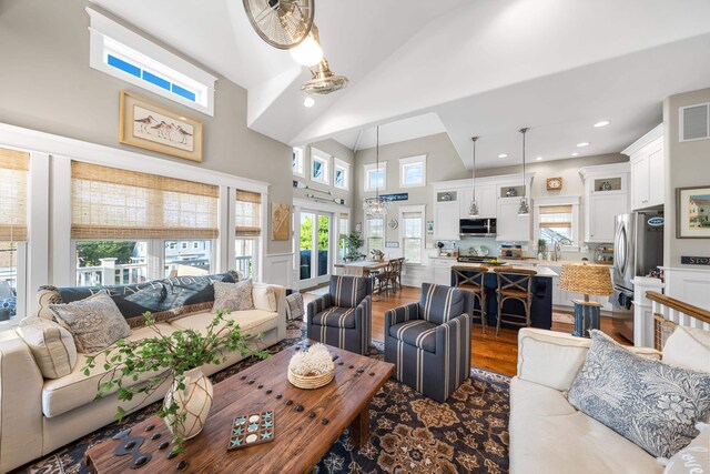 243 110th St, Stone Harbor, NJ 08247 - living room with dark wood-style floors, high vaulted ceiling, and recessed lighting