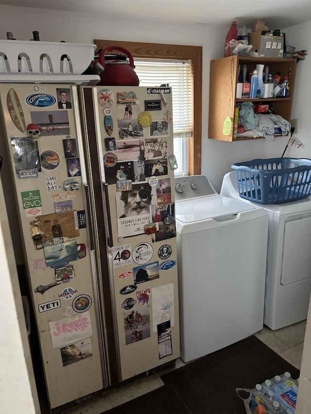 laundry room with light tile patterned flooring and separate washer and dryer