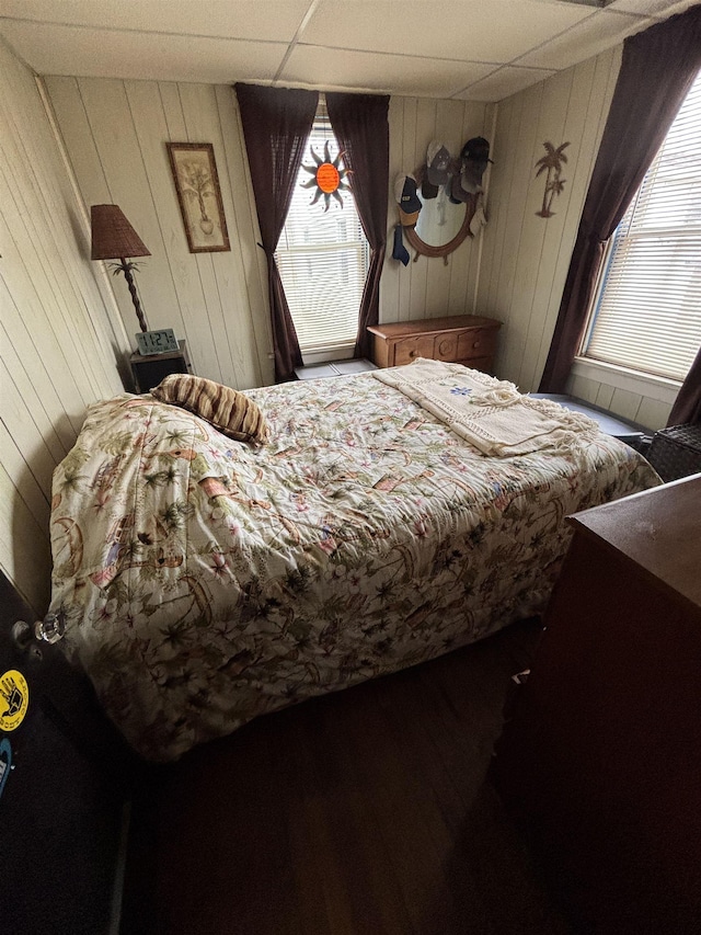 bedroom with multiple windows and a paneled ceiling