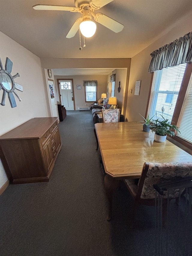 dining area with ceiling fan and dark carpet