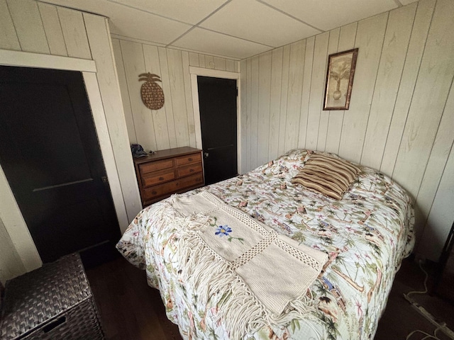 bedroom featuring wood walls