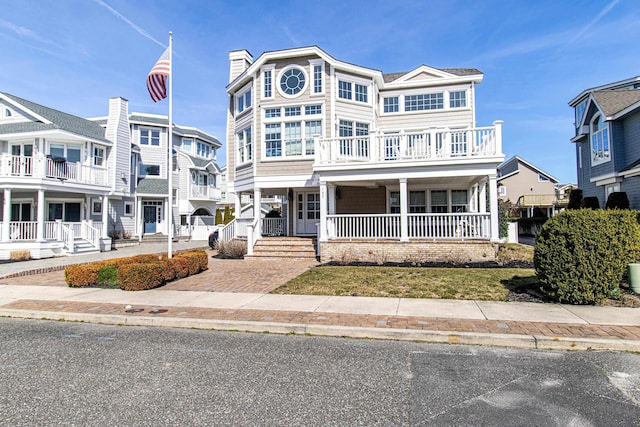 view of front of home with a balcony and covered porch