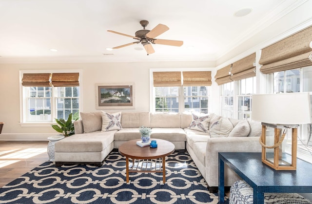 living room featuring crown molding, a healthy amount of sunlight, and hardwood / wood-style floors