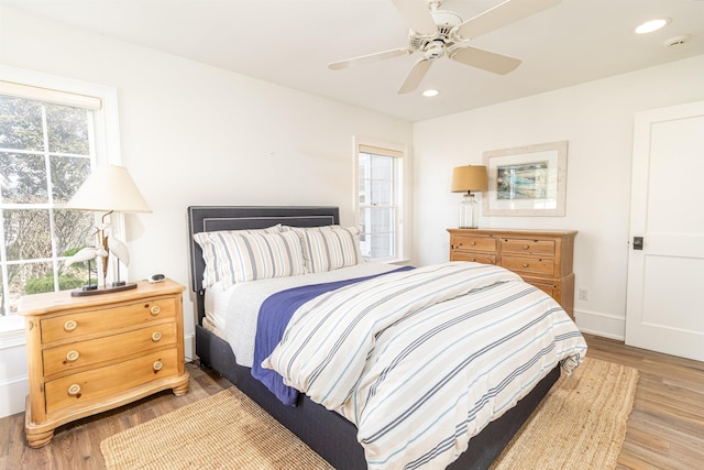 bedroom featuring light hardwood / wood-style flooring and ceiling fan