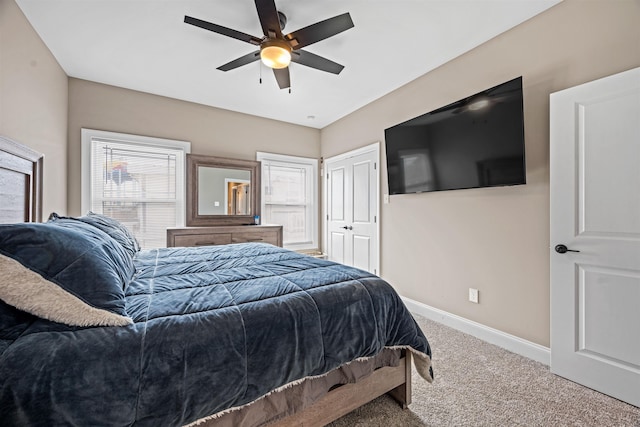 bedroom featuring carpet floors, a closet, ceiling fan, and baseboards