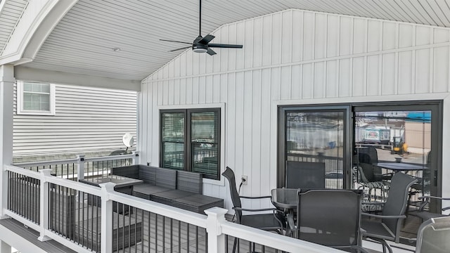 wooden terrace with ceiling fan and an outdoor hangout area