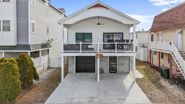 view of front of property featuring concrete driveway, an attached garage, and a ceiling fan