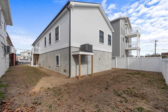 back of house with fence and central AC unit