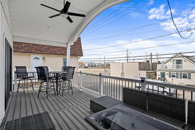 wooden deck featuring ceiling fan and outdoor dining space