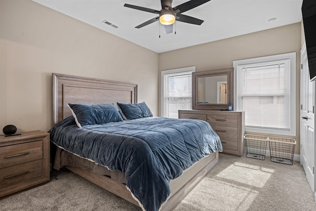 bedroom with carpet floors, ceiling fan, and visible vents