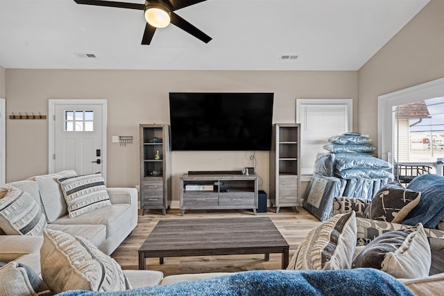 living area featuring visible vents, ceiling fan, and light wood finished floors