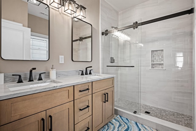 full bath featuring double vanity, a stall shower, a sink, and visible vents