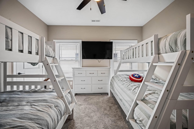 bedroom with visible vents, ceiling fan, carpet flooring, and multiple windows