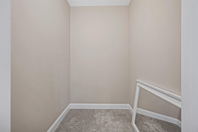 interior space featuring carpet flooring and baseboards