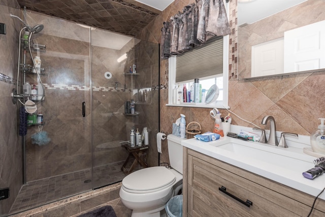 bathroom with vanity, a shower with shower door, and toilet