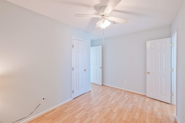 empty room with light wood-type flooring and ceiling fan