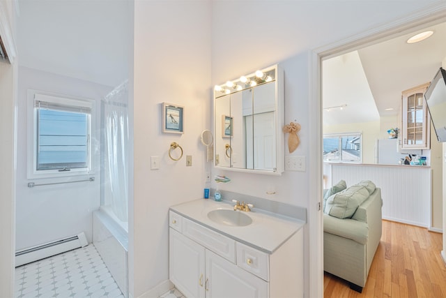 bathroom featuring vanity, a baseboard radiator, and hardwood / wood-style flooring