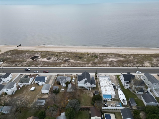 drone / aerial view with a water view and a beach view