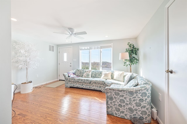 living room featuring ceiling fan and light hardwood / wood-style flooring