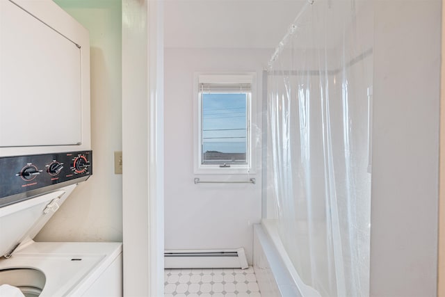 washroom with stacked washer / dryer and a baseboard heating unit