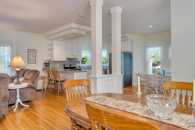 119 Stevens St, West Cape May, NJ 08204 - dining space featuring ornate columns, light wood-style floors, healthy amount of natural light, and recessed lighting