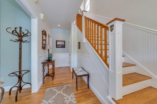 119 Stevens St, West Cape May, NJ 08204 - stairway with a wainscoted wall, wood finished floors, and recessed lighting