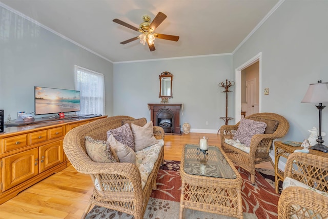 119 Stevens St, West Cape May, NJ 08204 - living area with ceiling fan, light wood-style floors, crown molding, and a fireplace