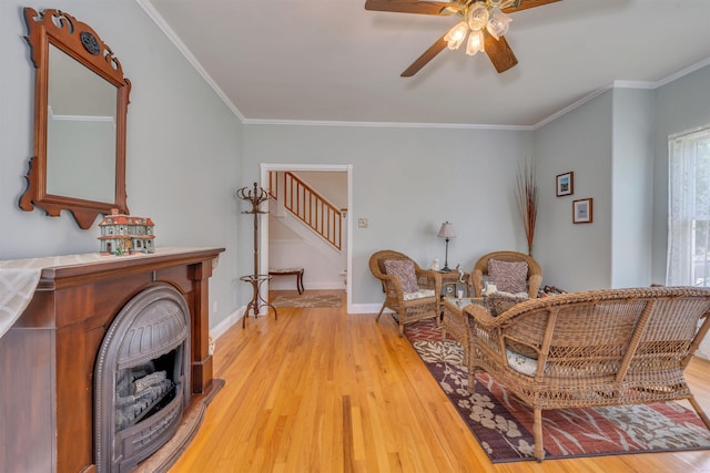 119 Stevens St, West Cape May, NJ 08204 - living area featuring a ceiling fan, light wood-style flooring, stairs, ornamental molding, and a fireplace
