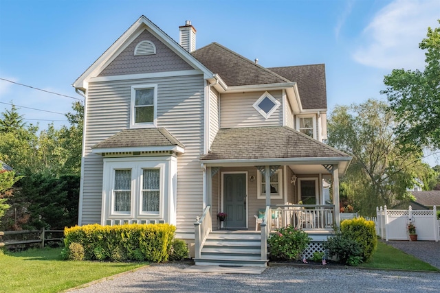 119 Stevens St, West Cape May, NJ 08204 - victorian-style house featuring a porch, roof with shingles, and a chimney